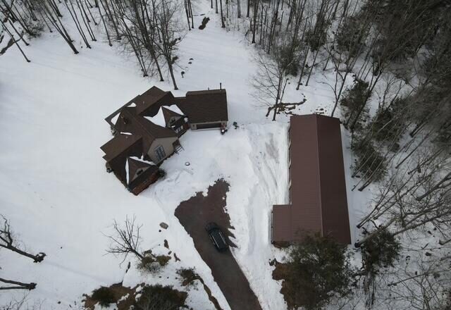 Aerial view of house and pole barn in winter